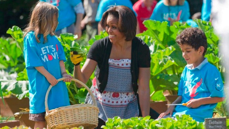 First lady Michelle Obama tends to the White House garden with a group of children as part of her 