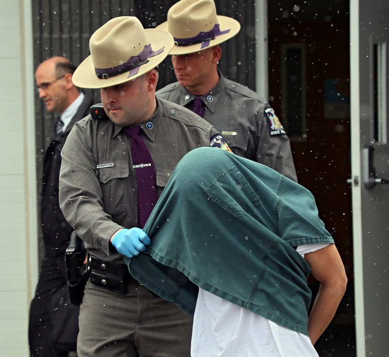 New York State Police lead David Renz out of the North Syracuse state police barracks Friday, March 15, 2013. Renz, 29, abducted a school librarian and her daughter as they left a gymnastics class at a mall in the Syracuse suburb of Clay at about 9 p.m. Thursday, according to state police. Troopers said he bound both victims, raped the child and drove a short distance to a spot where the girl managed to escape, possibly as her mother was being killed. She was helped by a passing motorist and was being treated at a hospital. Her mother died from multiple stab wounds. Renz was caught by a trooper as he tried to escape into some woods, police said. (AP Photo/The Syracuse Newspapers, Dick Blume) NO SALES