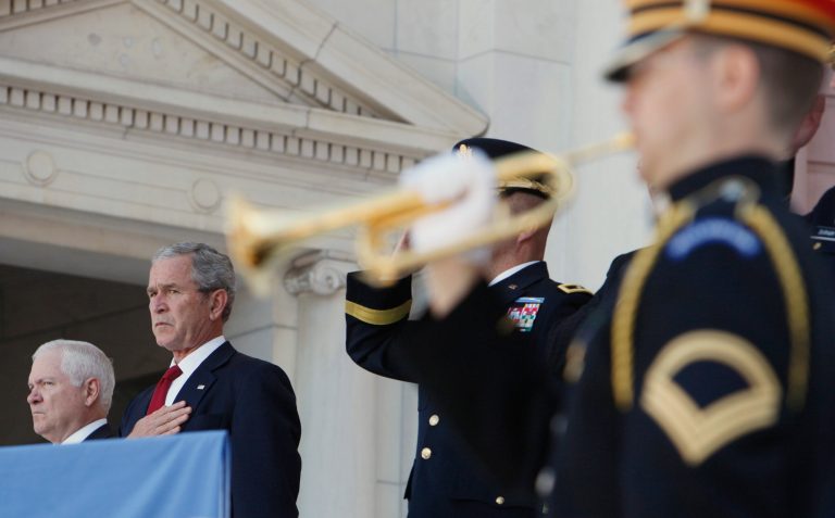 President George W. Bush stands during the playing of taps at a Memorial Day ceremony, May 26, 2008, at Arlington National Cemetery. (AP Photo)