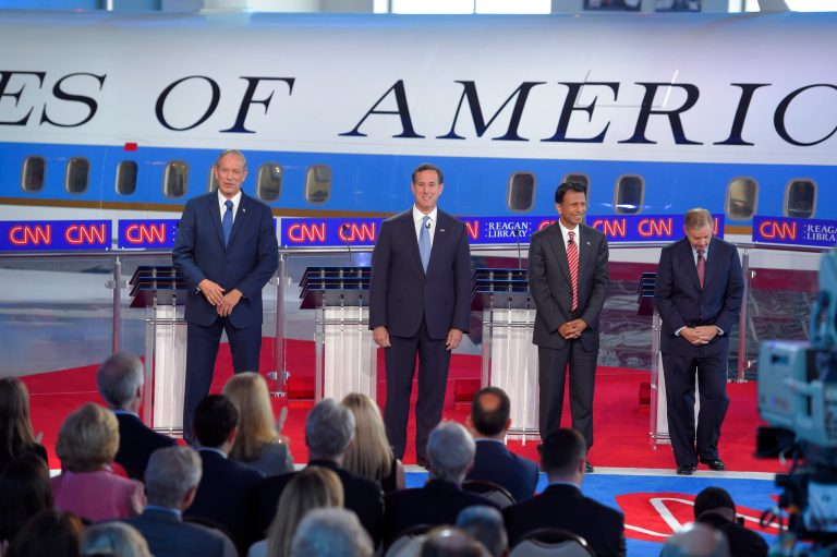 GOP presidential candidates (from left) former N.Y. Gov. Pataki, former Pennsylvania Sen. Santorum, Louisiana Gov. Jindal and Sen. Lindsey Graham, R-S.C., take the stage in the early CNN Republican presidential debate. (AP Photo/Mark J. Terrill)