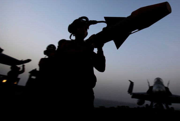 Sailors carry a missile at sunset on the flight deck of the U.S. Navy aircraft carrier USS George H.W. Bush on Sunday, Aug. 10, 2014 in the Persian Gulf. Aircrafts aboard the George H.W. Bush are flying missions over Iraq after U.S. President Barack Obama authorized airstrikes against Islamic militants and food drops for Iraqis trapped by the fighters. (AP Photo/Hasan Jamali)