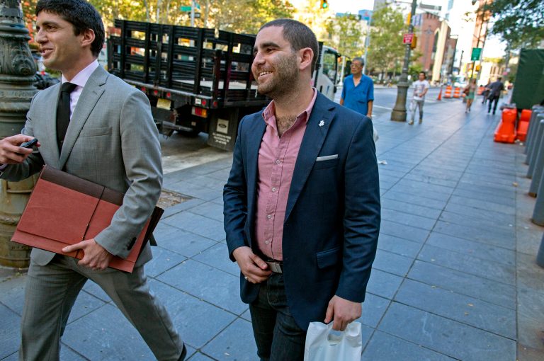 Charles Shrem, center, the top executive of a New York City-based Bitcoin company, walks from the federal court house in New York Thursday, Sept. 4, 2014, after pleading guilty to federal charges that he helped smooth the way for drug transactions on the online marketplace Silk Road. (AP Photo/Craig Ruttle)