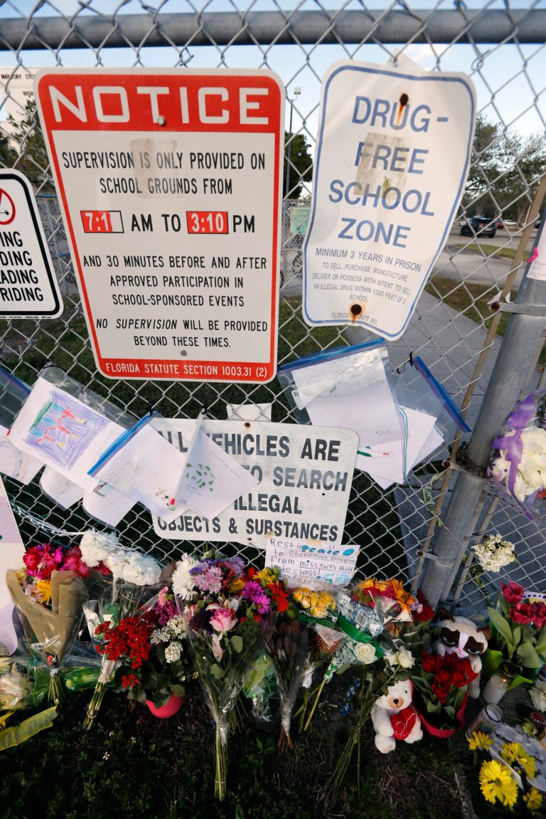 A makeshift memorial is seen outside the Marjory Stoneman Douglas High School, where 17 students and faculty were killed in a mass shooting on Wednesday, in Parkland, Fla., Monday, Feb. 19, 2018. Nikolas Cruz, a former student, was charged with 17 counts of premeditated murder on Thursday. (AP Photo/Gerald Herbert)