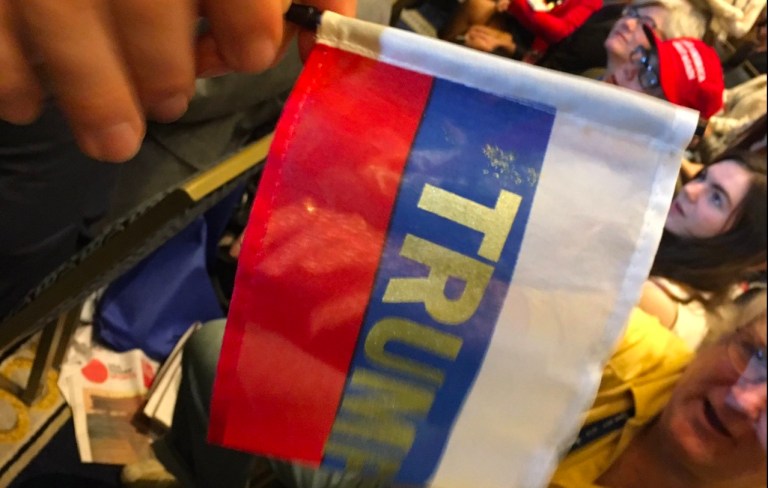 The flags were handed out before the speech but were confiscated while the speech took place. (Screengrab/Twitter)