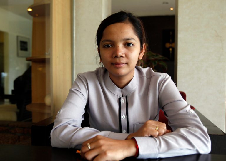 In this July 28, 2014, photo, Sok Sambour, 25, works as a receptionist at a hotel after graduating from accounting school. Her parents told her about that era, including exactly how long the Khmer Rouge rule lasted: three years, eight months and 20 days. An elderly neighbor told her that just catching a fish to eat was enough to be accused of betrayal and face almost certain execution. A U.N.-assisted genocide tribunal will deliver a verdict this coming Thursday in the trial of the two top leaders of the communist Khmer Rouge, whose extremist policies in the late 1970s are blamed for the deaths of an estimated 1.7 million Cambodians though starvation, medical neglect, overwork and execution. (AP Photo/Heng Sinith)