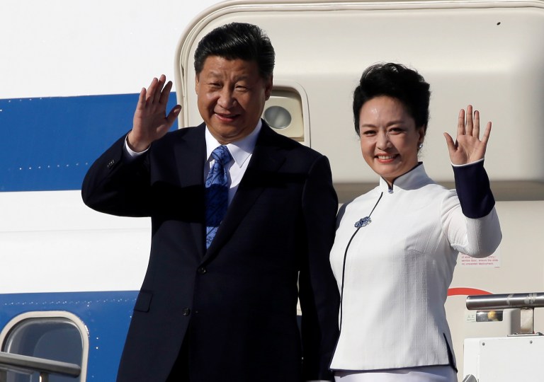 Chinese President Xi Jinping, left, and his wife Peng Liyuan wave upon arrival Tuesday, Sept. 22, 2015, at Boeing Field in Everett, Wash. (AP Photo/Elaine Thompson)