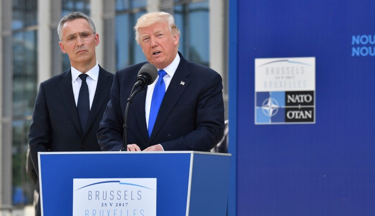 President Trump, right, speaks as NATO Secretary General Jens Stoltenberg looks on. Trump told NATO members they must 
