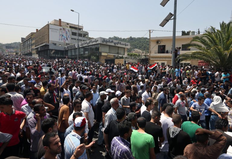Syrians who live in Lebanon gather in front of the Syrian embassy to vote in the presidential election in Yarze, east of Beirut, Lebanon, Wednesday, May 28, 2014. Thousands of supporters of Bashar Assad flocked to their embassy in Lebanon on Wednesday as expat voting started ahead of Syria's June 3 presidential election - a vote highly contentious amid the civil war but one that is widely expected to give the Syrian president a third seven-year term in office. (AP Photo/Bilal Hussein)
