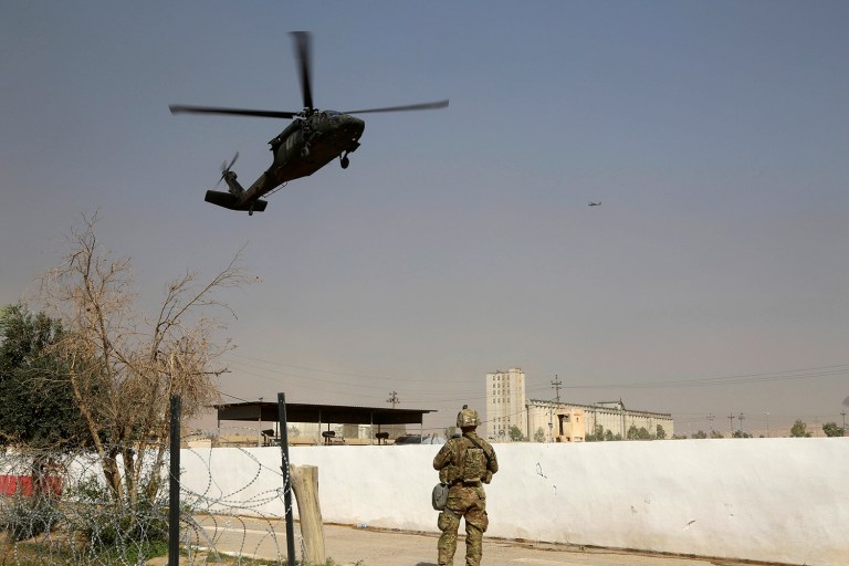 A U.S. Army soldier watches a helicopter belonging to the international coalition forces land on a base outside Mosul, Iraq, Wednesday, Oct. 19, 2016. (AP Photo)