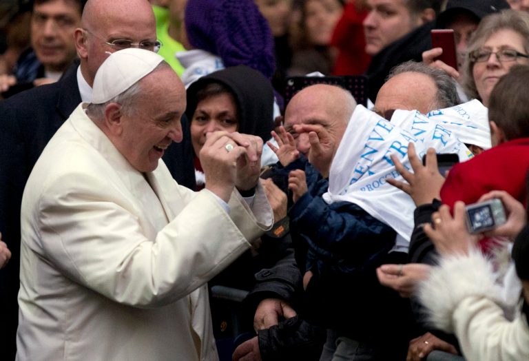 Pope Francis jokes with a child as he arrives at the Sacro Cuore church in Rome, Sunday, Jan. 19, 2014. (AP Photo/Alessandra Tarantino)