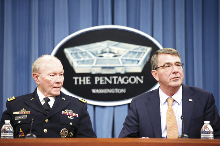 Defense Secretary Ash Carter, right, accompanied by Joint Chiefs Chairman Gen. Martin Dempsey, left, speaks during a news conference at the Pentagon. (AP Photo/Andrew Harnik, File)