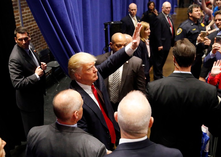 Republican presidential candidate Donald Trump waves goodbye to supporters after a campaign stop Monday in South Bend, Ind. (AP Photo/Charles Rex Arbogast)