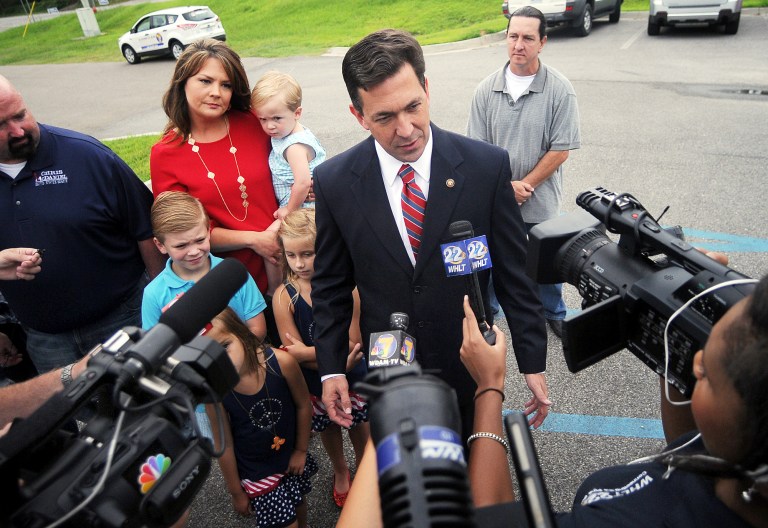 State Sen. Chris McDaniel speaks with the media before voting at the George Harrison Building Tuesday, June 24, 2014, in Ellisville, Miss.. Voters go to the polls Tuesday to vote in the Republican primary runoff election between incumbent Sen. Thad Cochran and challenger Chris McDaniel. The winner will face Democrat Travis Childers in the November general election. His wife Jill and family listen at rear left. (AP Photo/The Hattiesburg American, Bryant Hawkins)  NO SALES