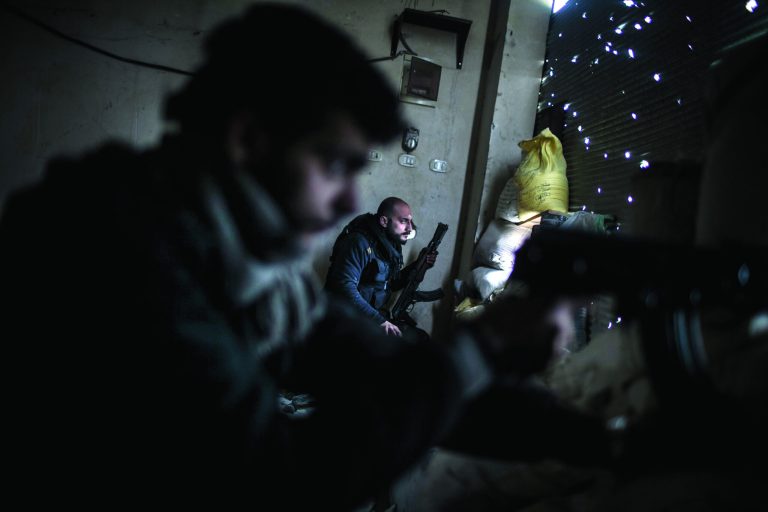 Free Syrian Army fighters hold their weapons during heavy clashes with government forces in Aleppo, Syria, Sunday, Jan. 20, 2013. The revolt against President Bashar Assad began in March 2011with peaceful protests but morphed into a civil war that has killed more than 60,000 people, according to a recent United Nations recent estimate. (AP Photo/Andoni Lubaki)