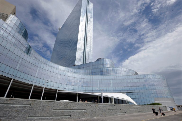 FILE - In this Sept. 1, 2014, file photo, Randy Chapman, left, of California, and John Krisel, of New York, walk on The Boardwalk after they checked out of the closing Revel Casino Hotel in Atlantic City, N.J. A bankruptcy court auction for Revel, the failed luxury casino-hotel on the Atlantic City Boardwalk, will resume on Tuesday, Sept. 30, 2014. (AP Photo/Mel Evans, File)