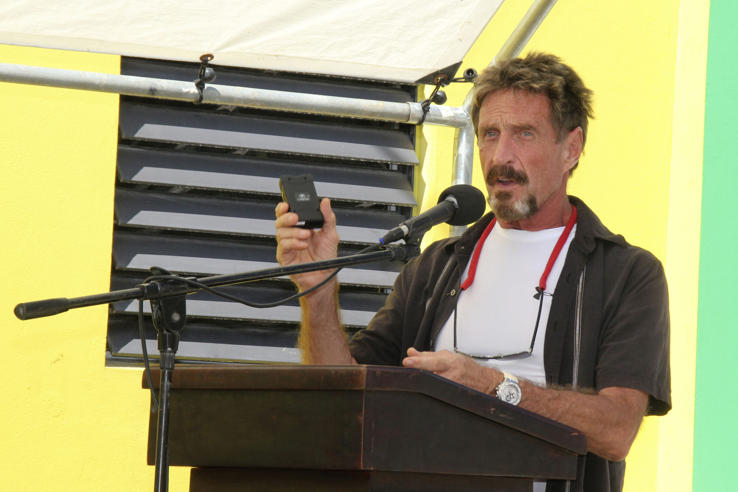 McAfee says he’s left Belize, is still on run
