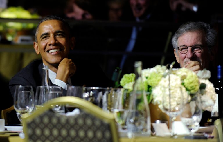 President Barack Obama, left, sits next to movie director Steven Spielberg, right, as they listen to Conan O'Brien during the USC Shoah Foundation's 20th anniversary Ambassadors for Humanity gala in Los Angeles, Wednesday, May 7, 2014. (AP Photo/Susan Walsh)