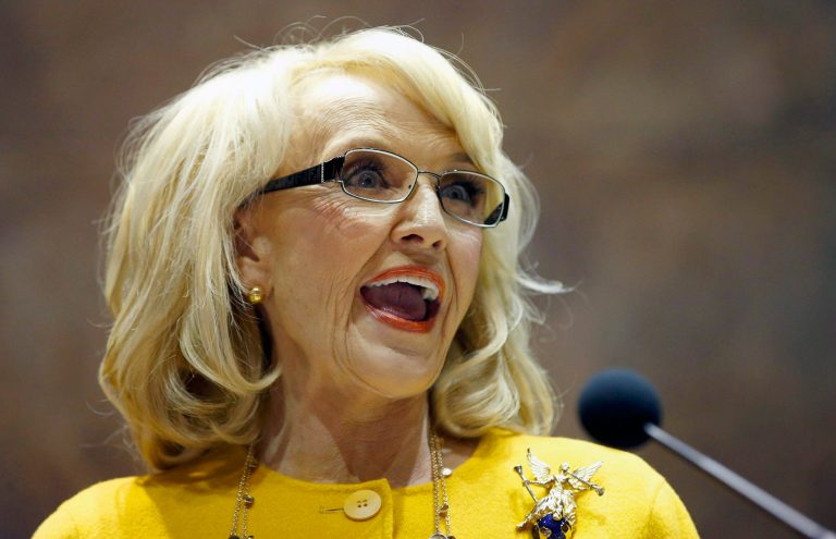 FILE - In this Jan. 13, 2014 file photo, Arizona Gov. Jan Brewer speaks during her State of the State address at the Arizona Capitol in Phoenix. The Republican governor faced intensifying pressure Tuesday from CEOs, politicians in Washington and state lawmakers in her own party to veto a bill that would allow business owners with strongly held religious beliefs to deny service to gays and lesbians. (AP Photo/Ross D. Franklin, File)
