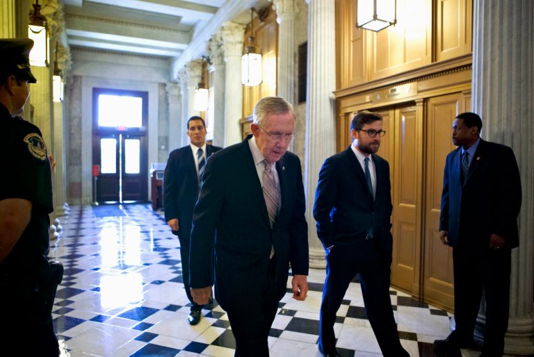   FILE - In the Sept. 6, 2013, file photo Senate Majority Leader, Democrat Harry Reid of Nevada heads to the Senate floor to introduce a resolution for the authorization of military action in support of President Barack Obama's request for a strike against Syria. Congress returns Monday, Sept. 9, to a momentous vote on whether the U.S. should attack Syria; that question overshadows the crowded, contentious agenda of budget fights, health care, farm policy and possible limits on the government's surveillance of millions of Americans. Many lawmakers stand in opposition to Obama's promised strikes amid fears of U.S. involvement in an extended Mideast war, and public fatigue after over decade-old conflicts in Iraq and Afghanistan. (AP Photo/J. Scott Applewhite, File)  