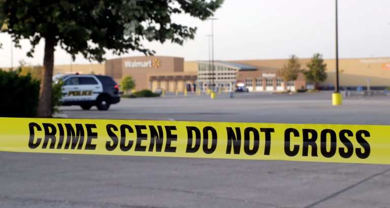 San Antonio police officers investigate the scene where 10 people were found dead in a tractor-trailer loaded with at least 30 others outside a Walmart store in stifling summer heat in what police are calling a horrific human trafficking case, Sunday, July 23, 2017, in San Antonio. (AP Photo/Eric Gay)