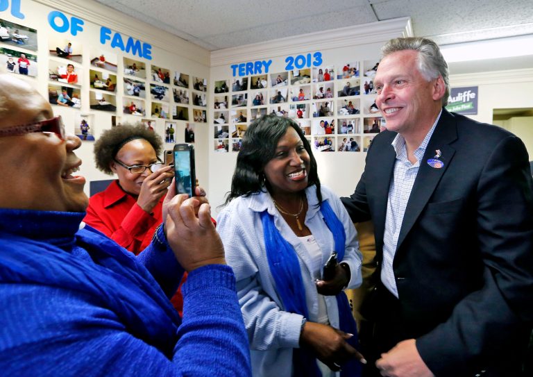 Virginia Democratic gubernatorial candidate Terry McAuliffe greets campaign workers, from left, Rose Roberson, Johnetta Seward and Gloria Barnes at a Chesterfield County, Va., campaign field office on Tuesday. (AP Photo/Richmond Times-Dispatch, Mark Gormus)