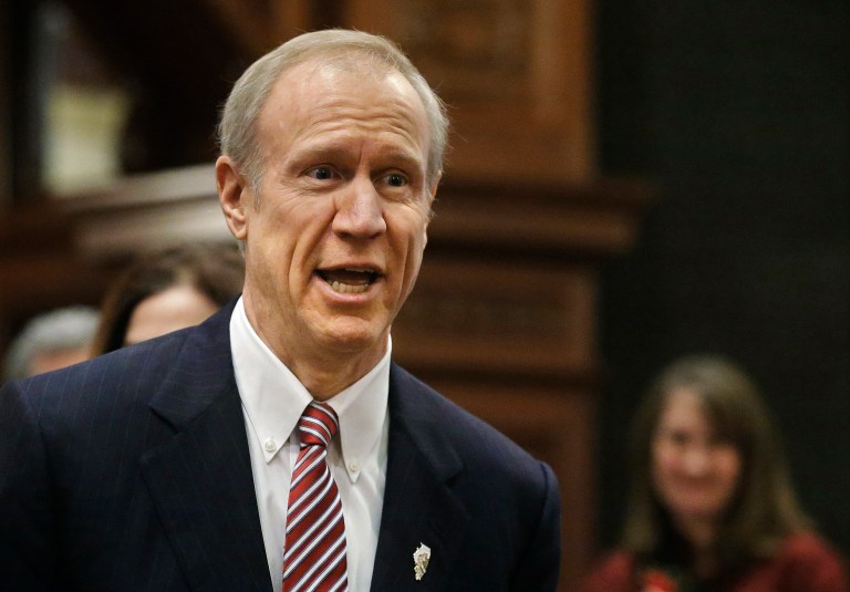 In this Feb. 4, 2015, file photo, Illinois Gov. Bruce Rauner acknowledges applause before delivering his State of the State address at the Capitol in Springfield, Ill. (AP Photo/Seth Perlman, File)