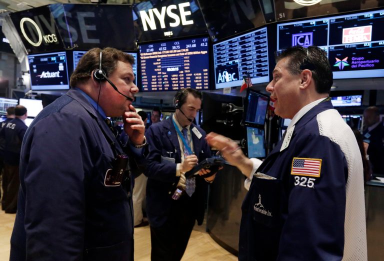 Traders John Santiago, left, and William McInerney, right, work on the floor of the New York Stock Exchange, Tuesday, May 13, 2014. The Standard & Poor's 500 index crossed above 1,900 for the first time Tuesday as investors assessed news on retail sales. DirecTV gained on reports that the AT&T is poised to buy the company for nearly $50 billion. (AP Photo)