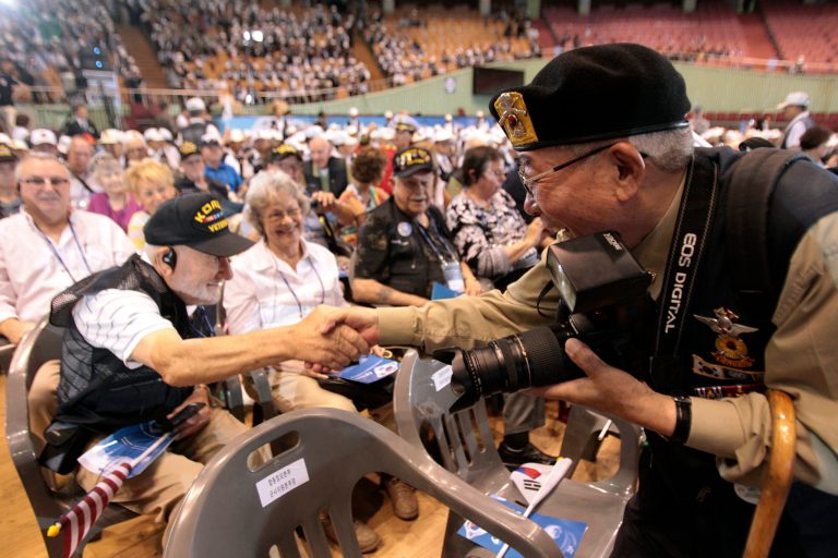 U.S. veteran  Fred R. Liberhan from Brooklyn, N.Y., left, shakes hands with South Korean war veteran Lee Gang-sung during a ceremony to mark the 64th anniversary of the outbreak of the Korean War in Seoul, South Korea, Wednesday, June 25, 2014. The three year Korean War broke out on June 25, 1950, when Soviet tank-led North Koreans invaded South Korea. (AP Photo/Ahn Young-joon)