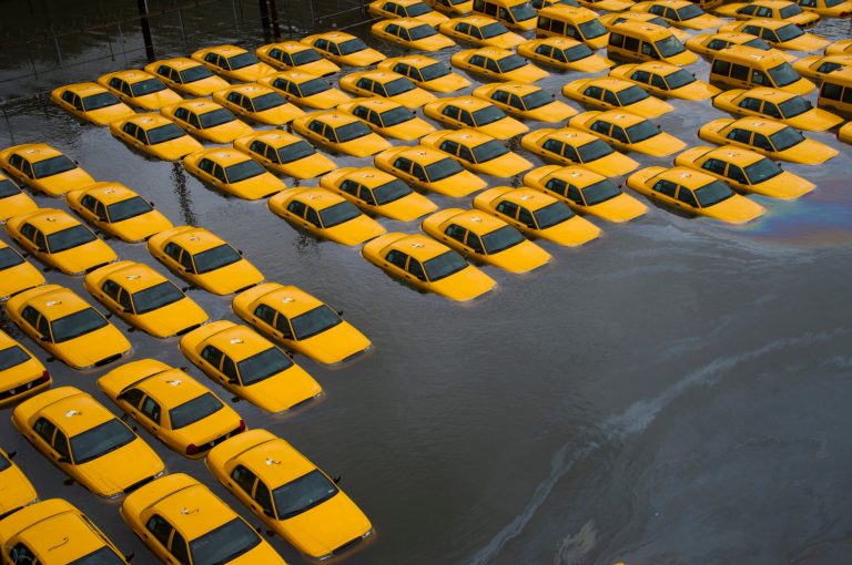 A parking lot full of yellow cabs in Hoboken, N.J. is flooded as a result of Superstorm Sandy. (AP/Charles Sykes)