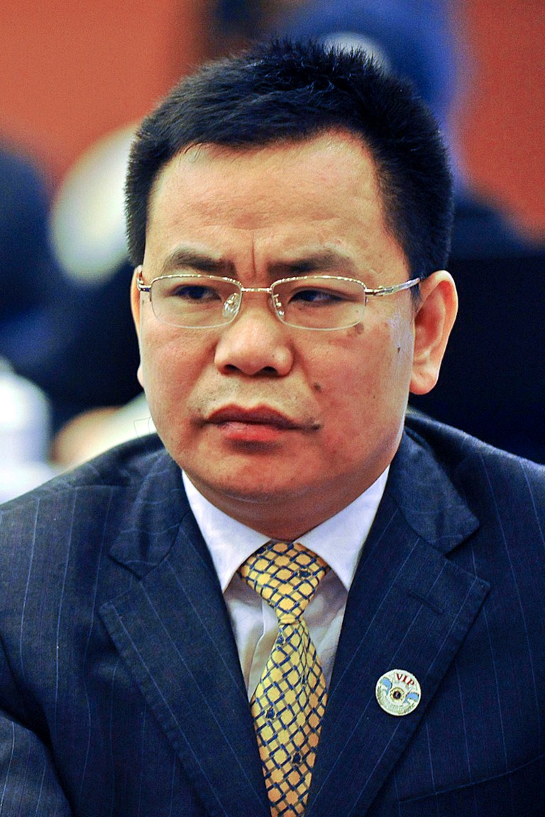   In this March 13, 2012 photo, businessman Lin Chunping attends a press conference in Wenzhou, in eastern China's Zhejiang province. In China, awash with fake iPhones, pirated DVDs of Hollywood blockbusters and knockoff Louis Vuitton bags, 41-year-old rice trader Lin took fakery to a whole new level: He invented a U.S. bank and claimed he bought it. (AP Photo) CHINA OUT  