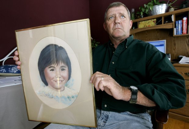 Jerry Ensminger holds a portrait of his daughter, Janey, in this May 9, 2007 file photo in White Lake, N.C. (Photo: Gerry Broome/AP file)