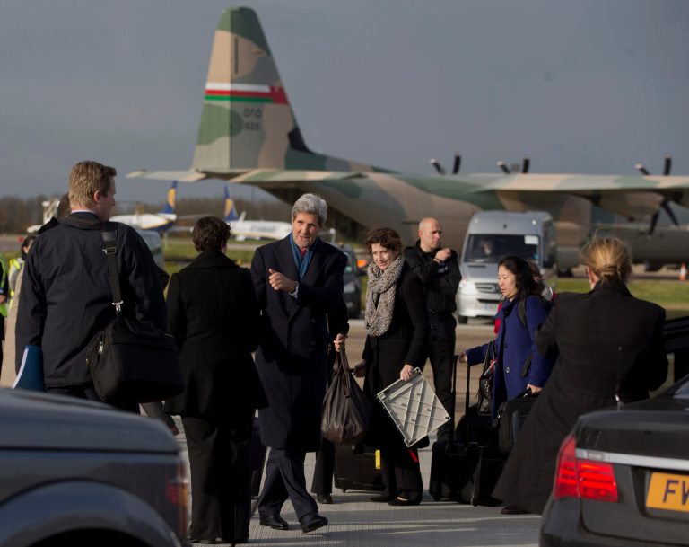 Secretary of State John Kerry walks from greeting staff on the tarmac to boards his aircraft at London's Stansted Airport, Monday, Nov. 25, 2013, en route to Washington. While in London Kerry had meetings with Libyan's Prime Minister Ali Zeidan and British Foreign Secretary William Hague. Prior to London, Kerry was in Geneva, Switzerland, for the Iran nuclear talks. European Union sanctions against Iran could be eased as soon as December, officials said Monday, after a potentially history-shaping deal that gives Tehran six months to increase access to its nuclear sites in exchange for keeping the core components of its uranium program. (AP Photo/Carolyn Kaster, Pool)
