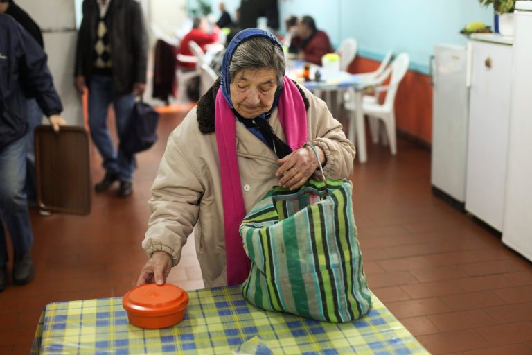 In this photo taken on Feb. 21, 2013, a needy elderly woman receives her daily meal in the dining hall of the Portuguese charity AMI - International Medical Assistance. center in Lisbon. The Portuguese charity AMI _ International Medical Assistance _ was set up almost three decades ago as a rapid response organization for catastrophes abroad. Now the emergency is at home. Before 2008, up to 8,000 people a year sought AMI's help in Portugal. In 2012, it was almost 16,000. In some places such as Porto, Portugal's second-largest city, the increase in people approaching the charity has been more than 250 percent since 2008. And some of the needy are university graduates. (AP Photo/Francisco Seco)
