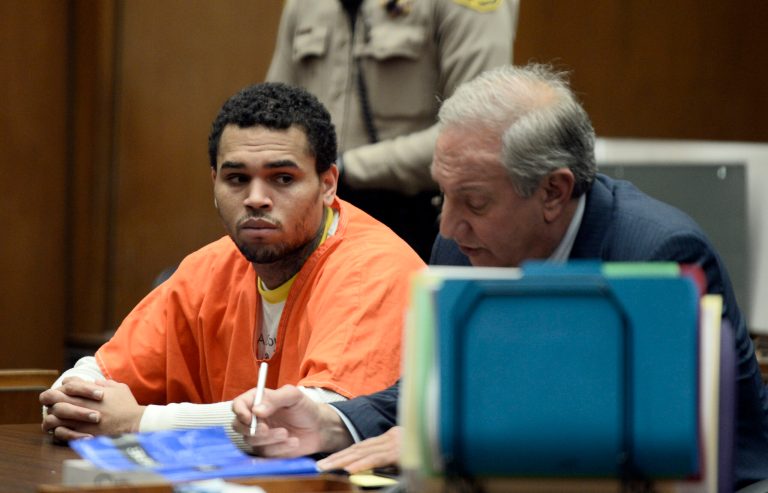 Chris Brown, left is shown in court with his attorney, Mark Geragos Friday May 9, 2014 in Los Angeles. Brown on Friday admitted a probation violation over an altercation last year outside a hotel in Washington, D.C., and was sentenced to remain on probation and serve an additional 131 days in jail. (AP Photo/Paul Buck, POOL)