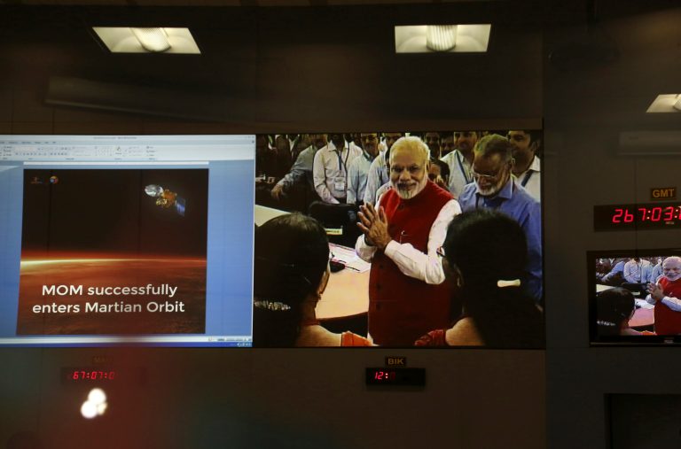Screens show Indian Prime Minister Narendra Modi greeting Indian Space Research Organisation scientists and other officials after the success of Mars Orbiter Mission at their Telemetry, Tracking and Command Network complex in Bangalore, India, Wednesday, Sept. 24, 2014. India triumphed in its first interplanetary mission, placing a satellite into orbit around Mars on Wednesday morning and catapulting the country into an elite club of deep-space explorers. (AP Photo/Aijaz Rahi)