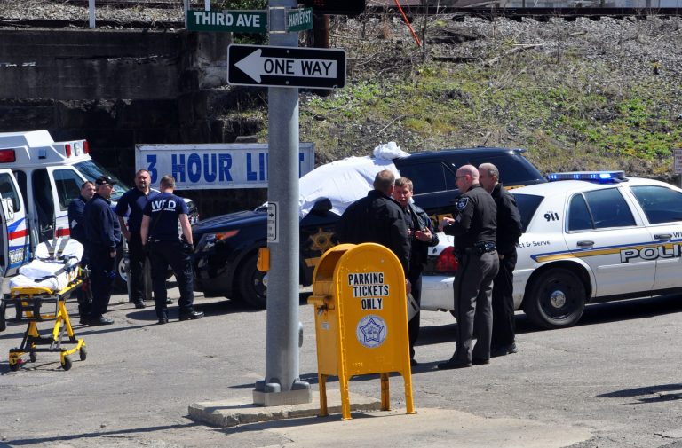Law enforcement officers and emergency service personnel converge on the scene of the shooting in downtown Williamson, W.Va., Wednesday, April 3, 2013, where Sheriff Eugene Crum was shot and killed at point blank range. (AP Photo/Williamson Daily News, Kyle Lovern)
