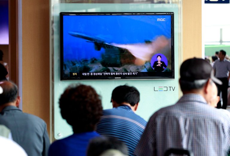 People watch a TV news program showing a file footage of a missile launch conducted by North Korea, at Seoul Railway Station in Seoul, South Korea, Wednesday, July 2, 2014. North Korea on Wednesday fired two short-range projectiles into waters off its east coast, South Korean officials said, on the eve of Chinese President Xi Jinping's talks in Seoul expected to focus on the North's nuclear weapons program.(AP Photo/Ahn Young-joon)