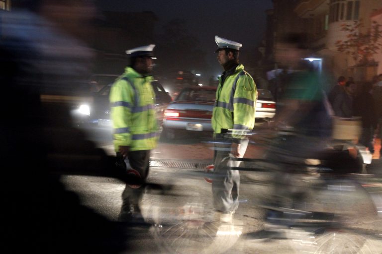   Afghan traffic policemen stand near the scene where Afghanistan's Intelligence Chief Asadullah Khalid was wounded in an assassination attempt on him in Kabul, Afghanistan, Thursday, Dec. 6, 2012. Afghanistan's intelligence chief was wounded Thursday in an assassination attempt in the capital, Kabul, Afghan officials said. (AP Photo/Ahmad Jamshid)  