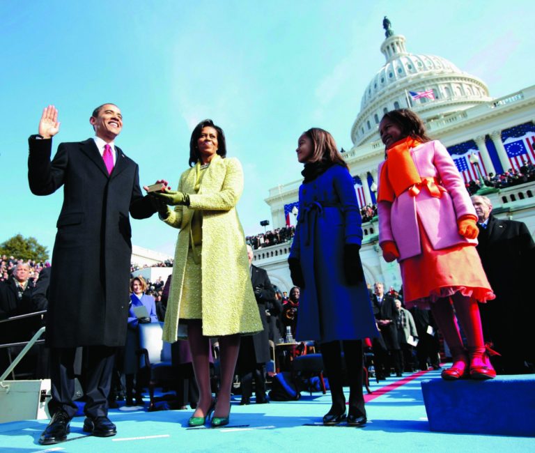 FILE - In this Jan. 20, 2009, file photo, Barack Obama, left, takes the oath of office from Chief Justice John Roberts, not seen, as his wife Michelle, holds the Lincoln Bible and daughters Sasha, right and Malia, watch at the U.S. Capitol in Washington. Obama's second inauguration is shaping up as a high-energy celebration smaller than his first milestone swearing-in, yet still designed to mark his unprecedented role in American history with plenty of eye-catching glamour. A long list of celebrity performers will give the once-every-four years right of democratic passage the air of a star-studded concert, from the bunting-draped Capitol's west front of the Capitol, where Obama takes the oath Jan. 21, to the Washington Convention Center, which is expected to be packed with 40,000 ball-goers that evening. (AP Photo/Chuck Kennedy, Pool)