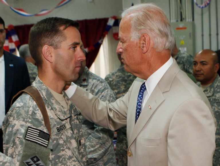 Vice President Joe Biden, right, talks with his son, U.S. Army Capt. Beau Biden, at Camp Victory on the outskirts of Baghdad, Iraq. On Saturday, May 30, 2015, Vice President Biden announced the death of son, Beau, from brain cancer. (AP Photo/Khalid Mohammed, Pool)