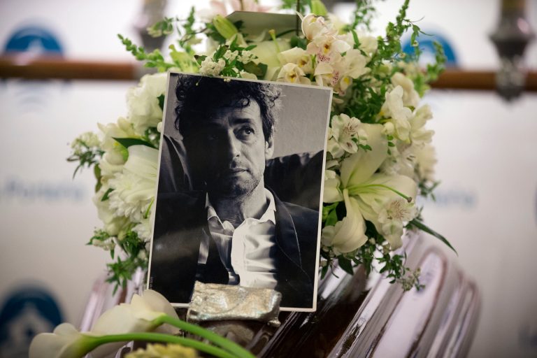 A photo of Argentine rock star Gustavo Cerati sits atop the coffin containing his body at the Buenos Aires City's Legislature, Argentina, Thursday, Sept. 4, 2014. Cerati died on Thursday, four years after a stroke put him in a coma and ended the career of one of Latin America's most influential musicians. (AP Photo/Victor R. Caivano)