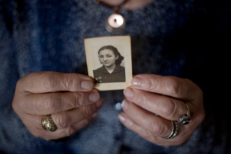 In this Thursday, April 4, 2013 photo, Warsaw ghetto Holocaust survivor Aliza Vitis-Shomron holds a photograph of herself when she was about 17 years old as she sits in her living room in Kibbutz Givat Oz, Israel. Two days before her comrades embarked on an uprising that came to symbolize Jewish resistance against the Nazis in World War II, 14-year-old Aliza Mendel got her orders: Escape from the Warsaw Ghetto. The end was near. Nazi troops had encircled the ghetto, and the remaining Jewish rebels inside were prepared to die fighting. Her job, they told her, was to survive and tell the world about how the fighters died resisting the Nazis. In the 70 years since the revolt, she's been doing just that, publishing a memoir about life in the ghetto and lecturing about the uprising.(AP Photo/Ariel Schalit)