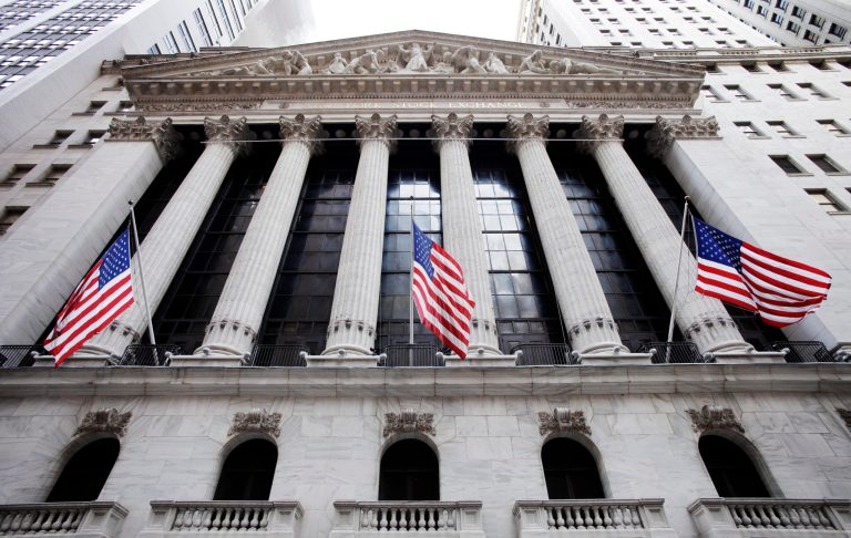 FILE - In this Feb. 10, 2011, file photo, American flags fly in front of the New York Stock Exchange, in New York. Stock markets fell Monday, Sept. 22, 2014, ahead of a preliminary manufacturing survey from China that might show renewed weakness in the world's second-largest economy. (AP Photo/Mark Lennihan, File)
