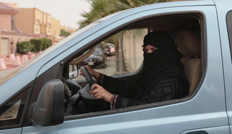 FILE- In this Saturday, March 29, 2014 file photo, a woman drives a car in Riyadh, Saudi Arabia, as part of a campaign to defy Saudi Arabia's ban on women driving. Saudi Arabia authorities announced Tuesday Sept. 26, 2017, that women will be allowed to drive for the first time in the ultra-conservative kingdom from next summer, fulfilling a key demand of women's rights activists who faced detention for defying the ban. (AP Photo/Hasan Jamali, FILE)