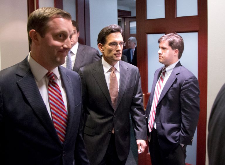   Majority Leader Eric Cantor from Virginia, center, departs after a House Republicans meeting on Capitol Hill, Thursday, Dec. 20, 2012 in Washington. Confronted with a revolt among the rank and file, House Republicans abruptly put off a vote Thursday night on legislation allowing tax rates to rise for households earning $1 million and up.(AP Photo/Alex Brandon)  