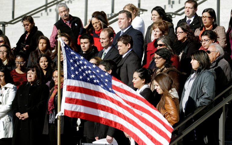 In this Nov. 21, 2014, file photo, about 50 activists and members of immigrant families stand during a news conference at Utah's capitol in Salt Lake City, to celebrate Obama's plans for deportation relief and work permits. (AP File Photo)