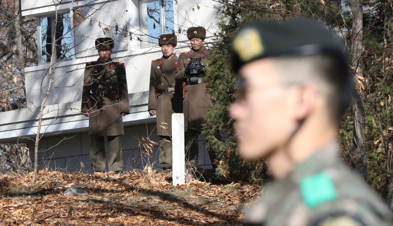North Korean soldiers look at the South side as a South Korean stands guard in the Demilitarized Zone, South Korea. The United Nations imposed new sanctions against the rogue nation after its latest ballistic missile test. (AP Photo/Lee Jin-man, File)