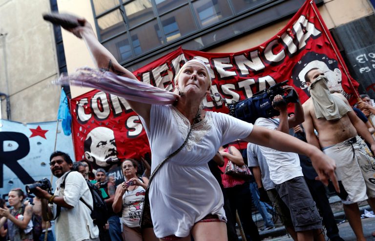   A protester hurls a stone at police officers during a protest against the acquittal of 13 people accused in the disappearance of a young woman in Buenos Aires, Argentina, Wednesday, Dec. 12, 2012. The acquittal on Tuesday of 13 people accused in the disappearance of Marita Veron, a young woman who was allegedly kidnapped and forced into prostitution for 