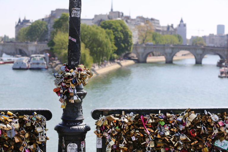 Love locks are fixed on the Pont des Arts in Paris, Wednesday April 16, 2014. A recent fad among travellers of hitching padlocks on bridges and at tourist attractions worldwide to symbolically immortalize their amorous attraction has swept up this reputed City of Love more than most. Now, two American-born women who live in Paris say they've had enough, launching a petition drive to try to get mostly laissez-faire city officials to step in and do something about what they call an unbearable eyesore in a majestic municipality. (AP Photo/Remy de la Mauviniere)