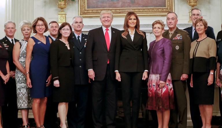 President Donald Trump and first lady Melania Trump, center, poses for a group photo with senior military leaders and spouses in the State Dining Room of the White House in Washington, Thursday, Oct. 5, 2017. Trump was hosting the dinner for the group. (AP Photo/Pablo Martinez Monsivais)